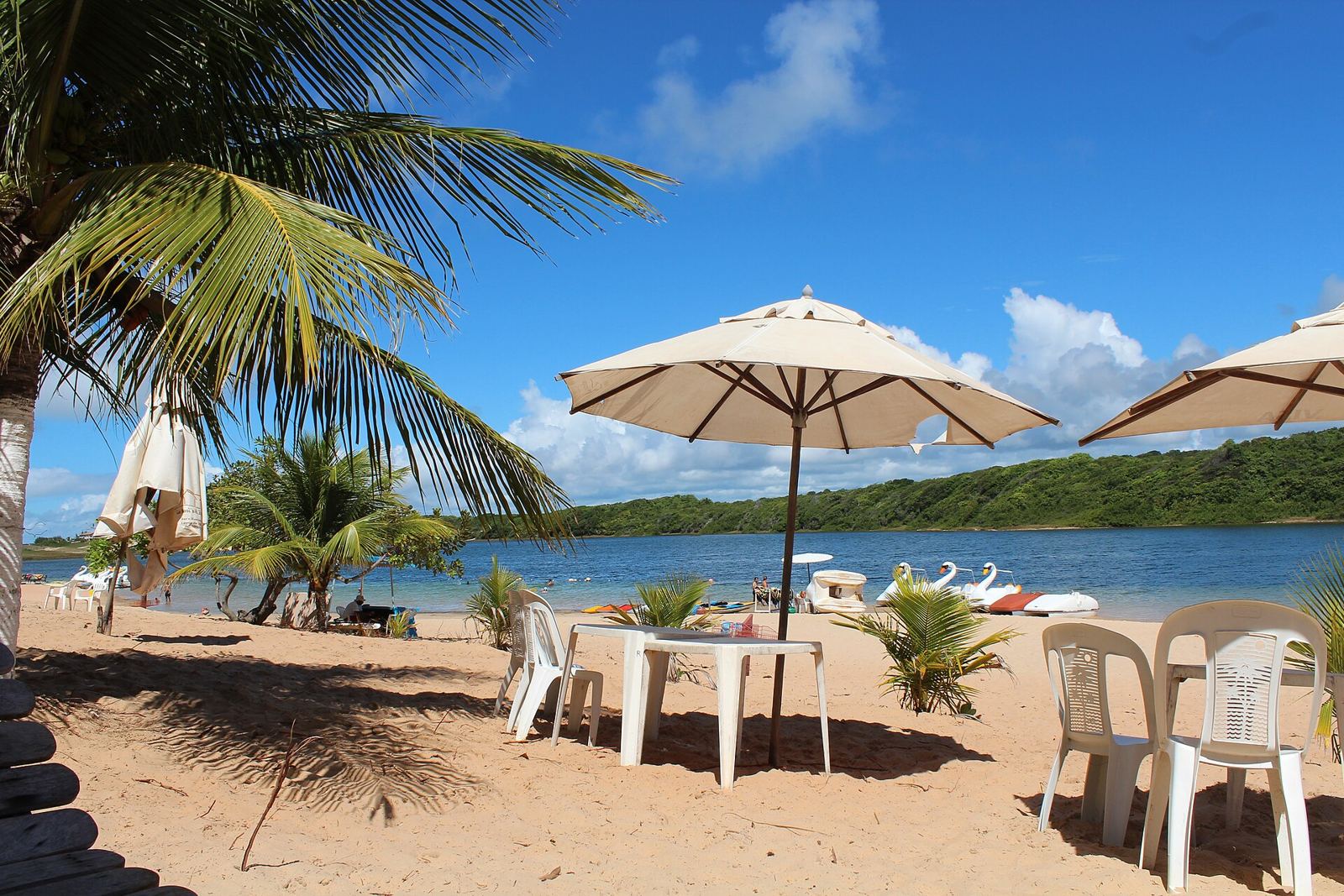 Lagoa de Arituba com guarda-sóis e água calma, ideal para famílias com crianças
